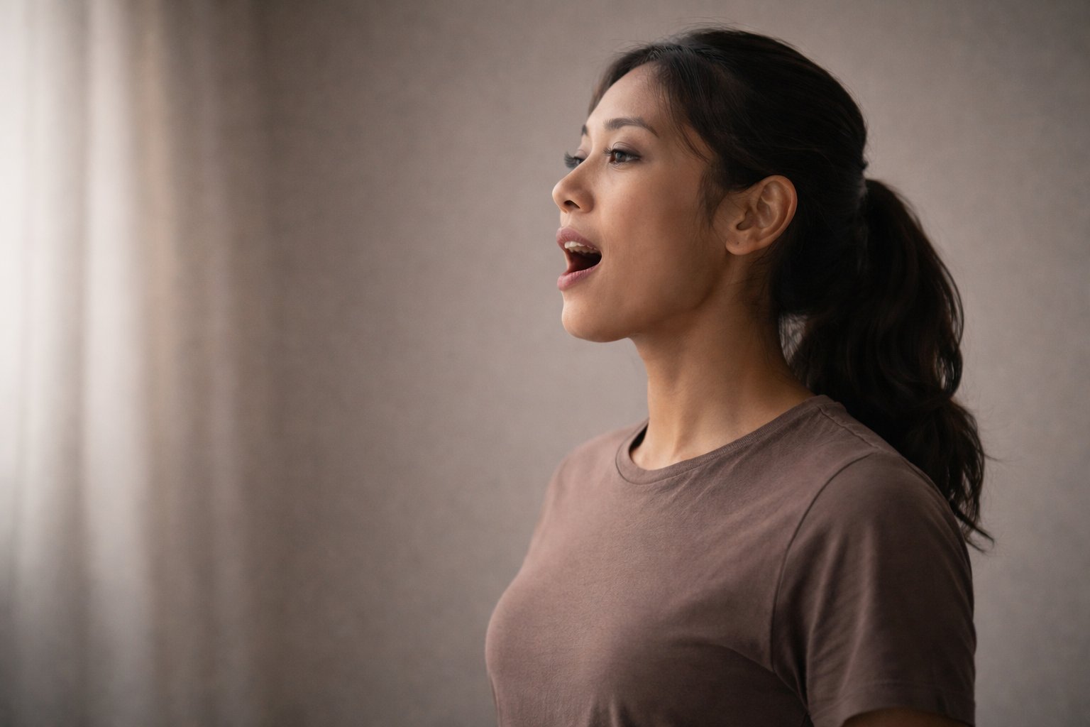 Singer beginning a phrase demonstrating seamless transition from breath into sound and coordinated vocal timing